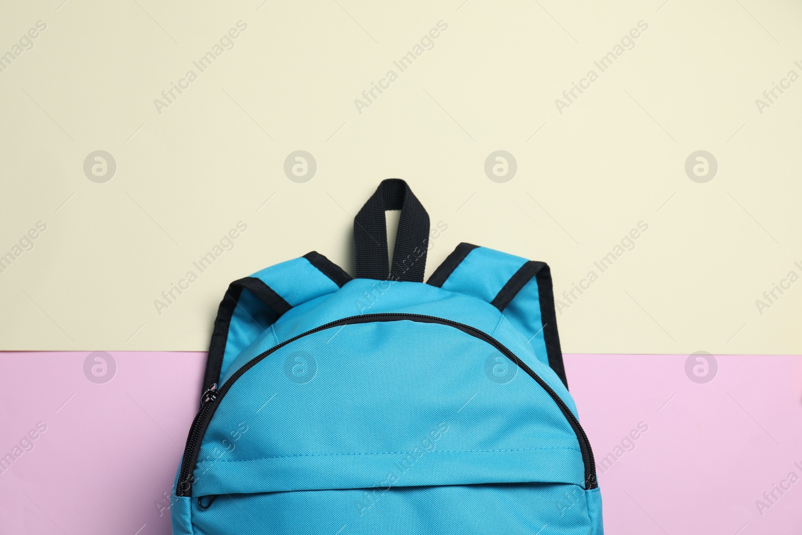 Photo of Stylish light blue backpack on color background, top view