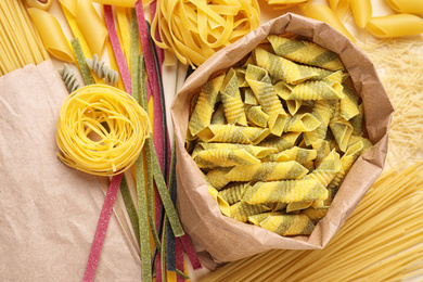 Photo of Different types of uncooked pasta , top view