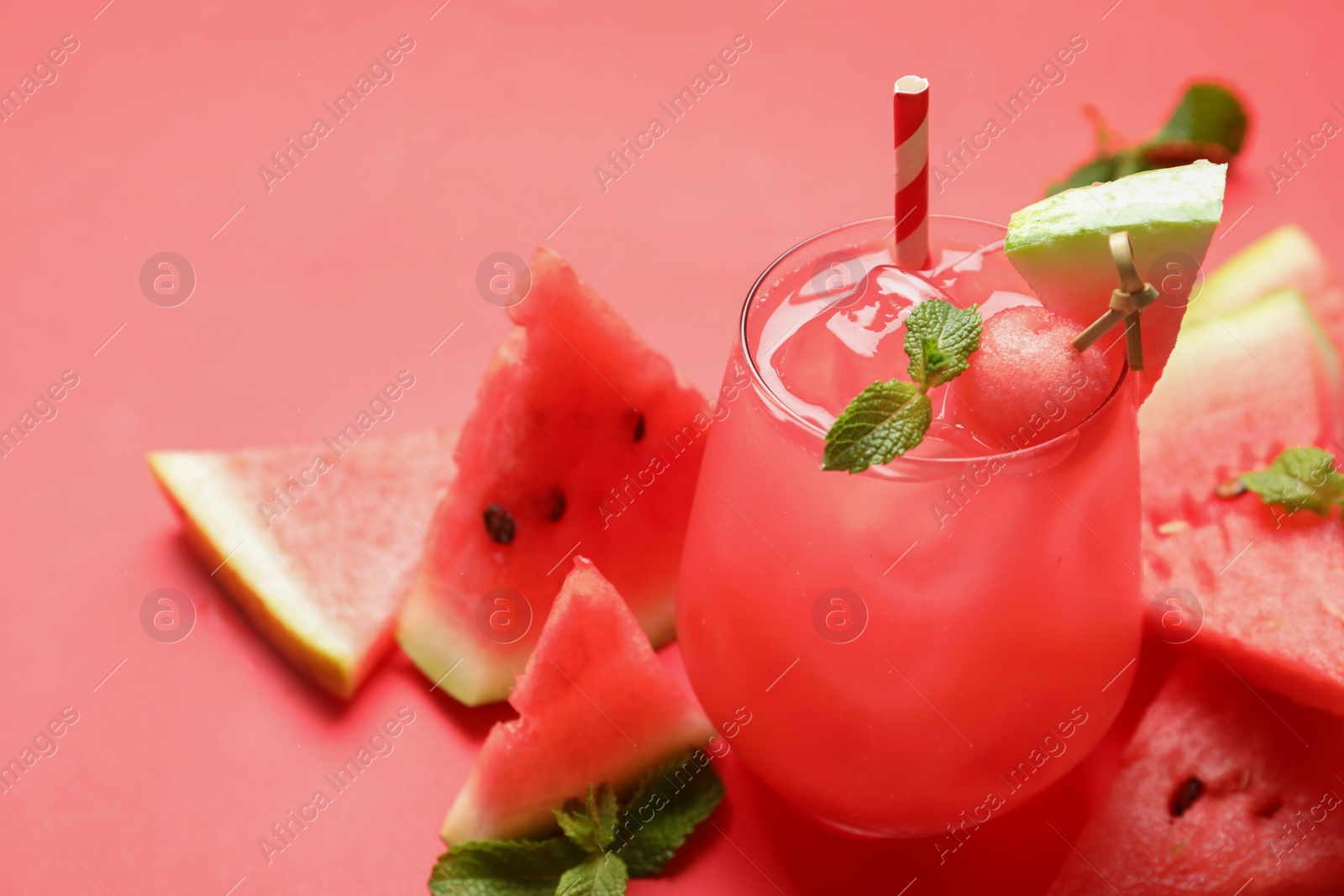 Photo of Tasty watermelon drink and fresh fruits on red background, space for text