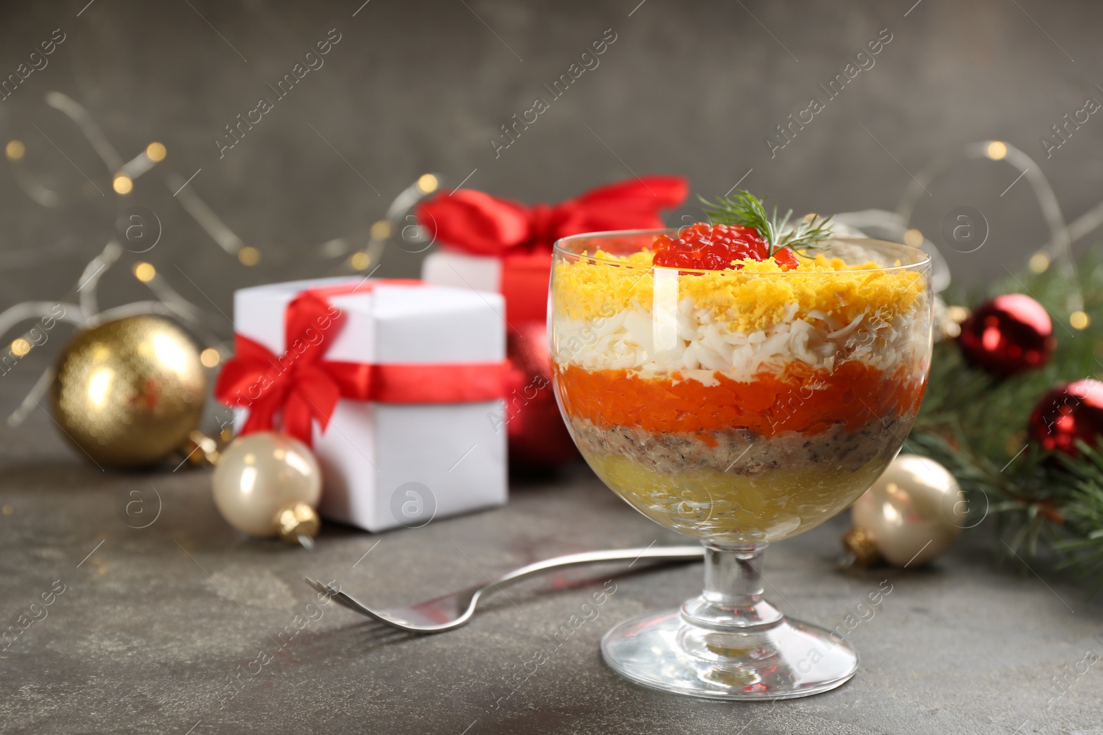 Photo of Traditional russian salad Mimosa served on grey table, space for text