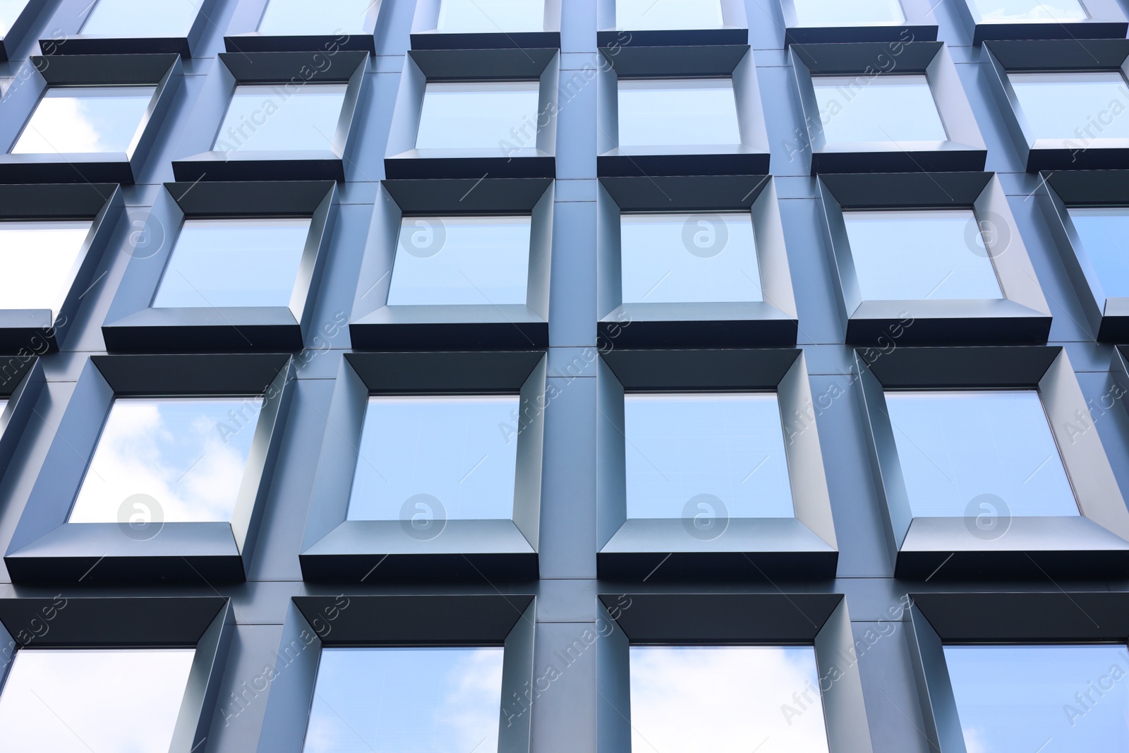 Photo of Modern building with tined windows, low angle view