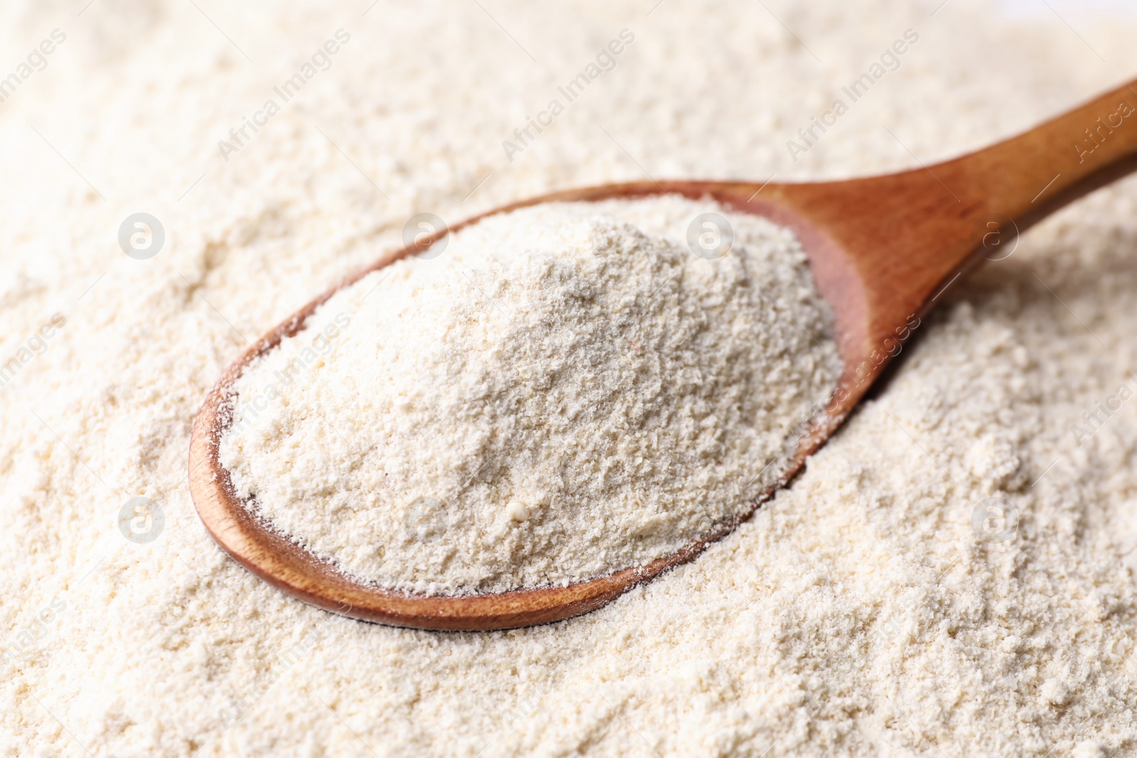 Photo of Quinoa flour and wooden spoon, closeup view