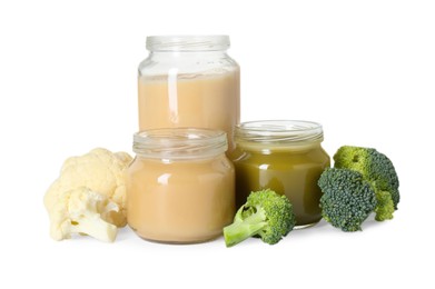 Tasty baby food in jars and fresh vegetables isolated on white