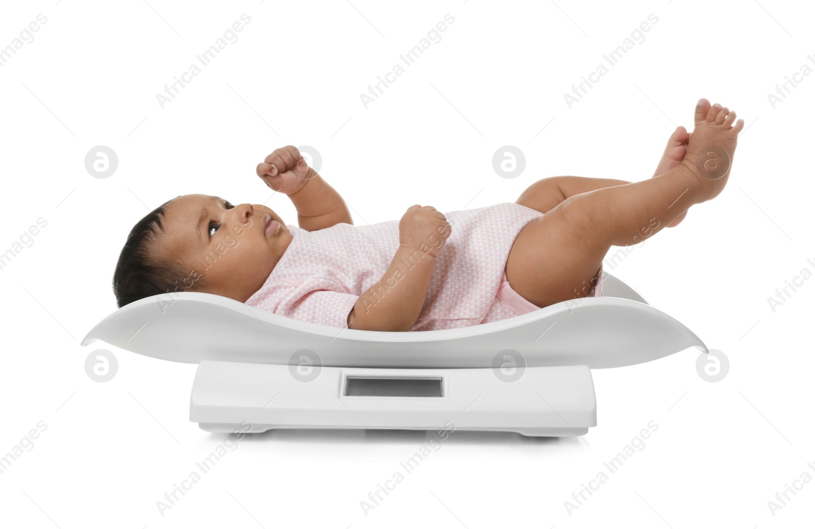 Photo of African-American baby lying on scales against white background