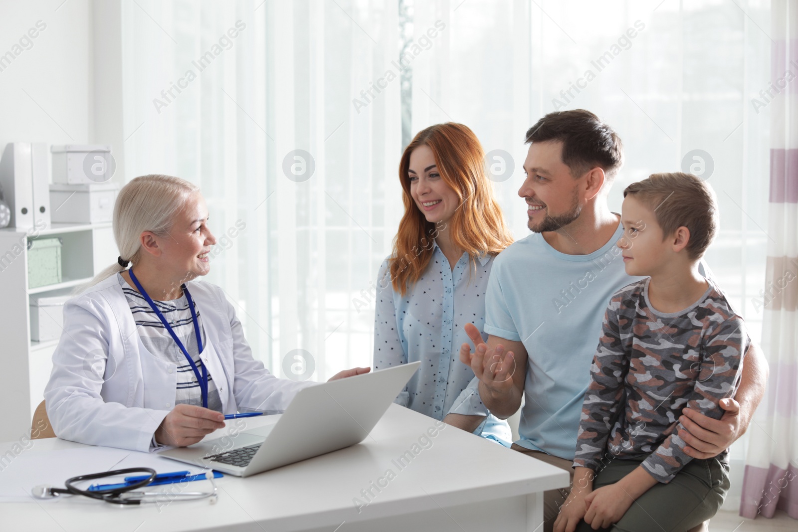 Photo of Family with child visiting doctor in hospital