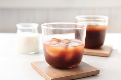 Glass with cold brew coffee on table