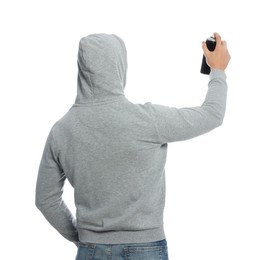 Man holding black can of spray paint on white background, back view