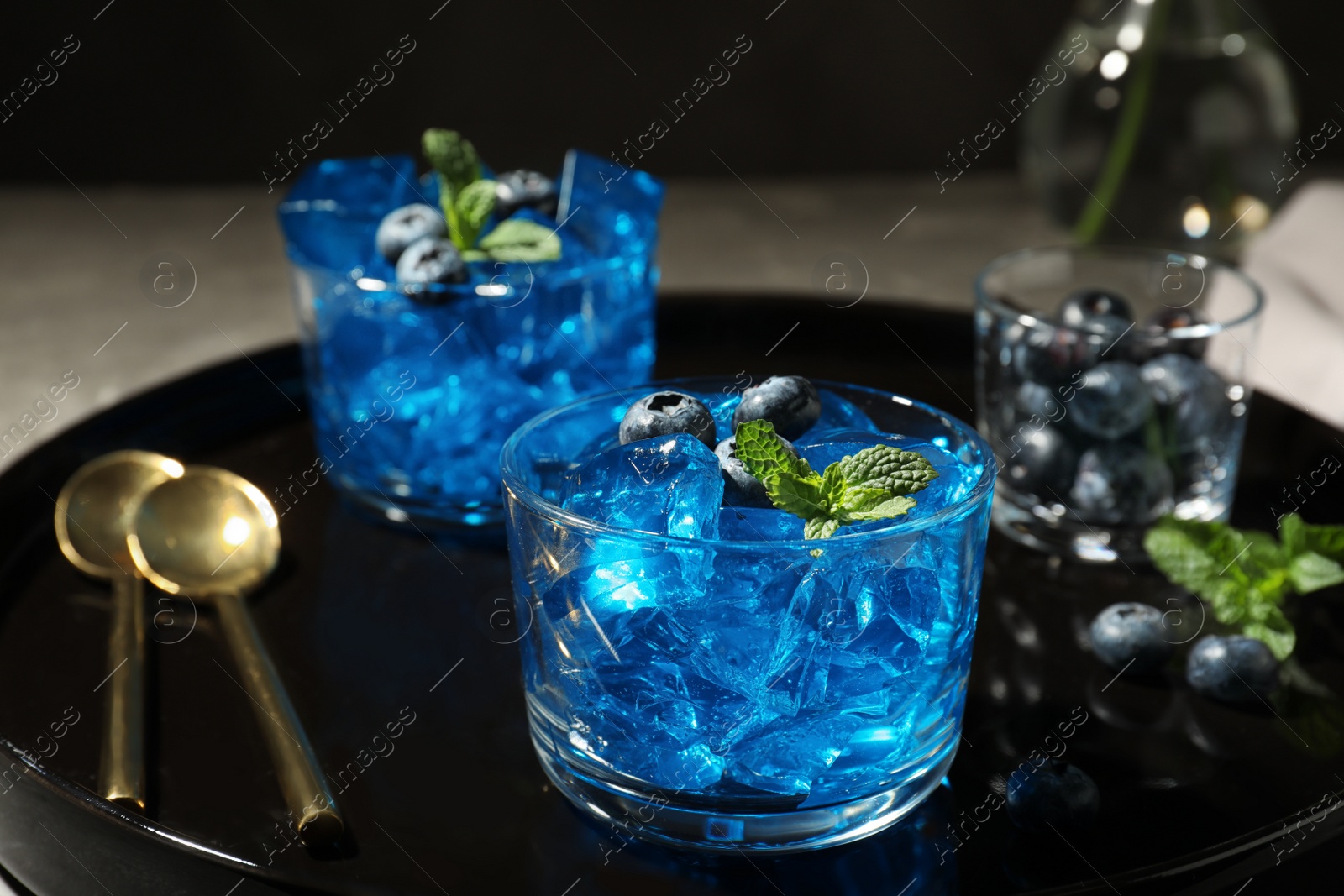 Photo of Glass of berry jelly on tray, closeup