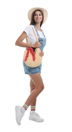 Photo of Beautiful young woman with stylish straw bag on white background