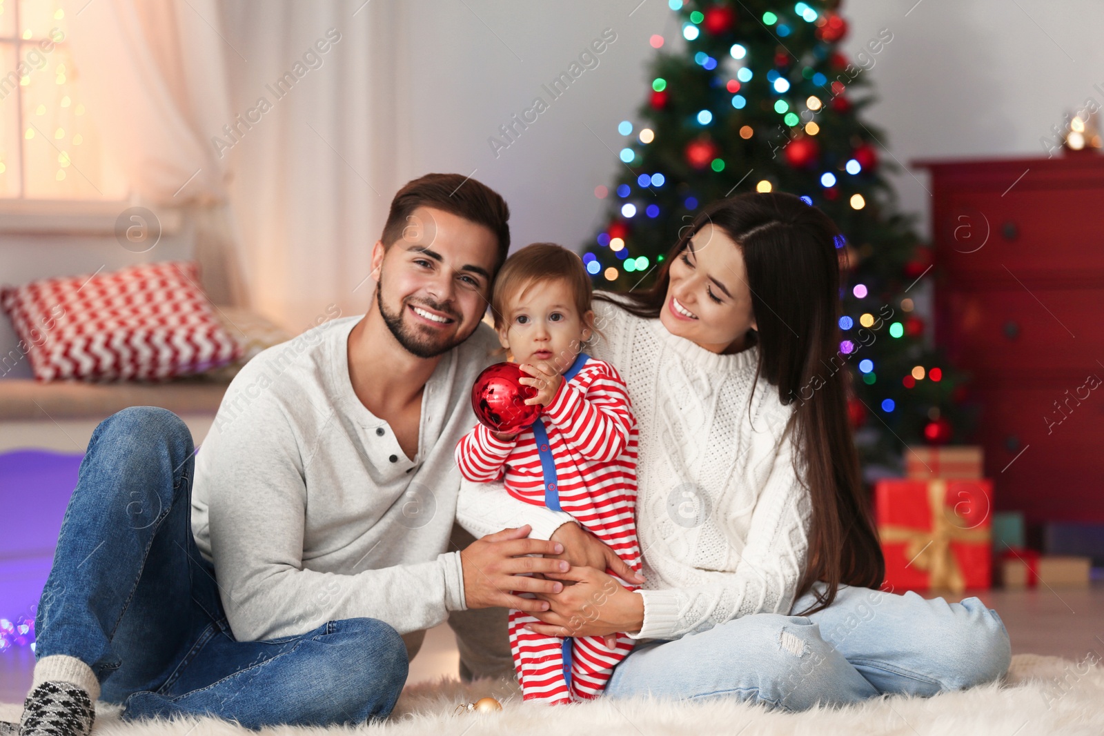 Photo of Happy family with cute baby at home. Christmas celebration