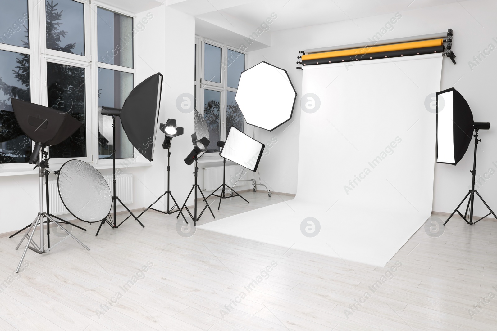 Photo of Interior of modern photo studio with professional lighting equipment