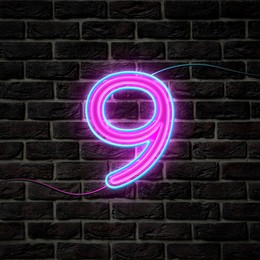 Image of Glowing neon number 9 sign on brick wall