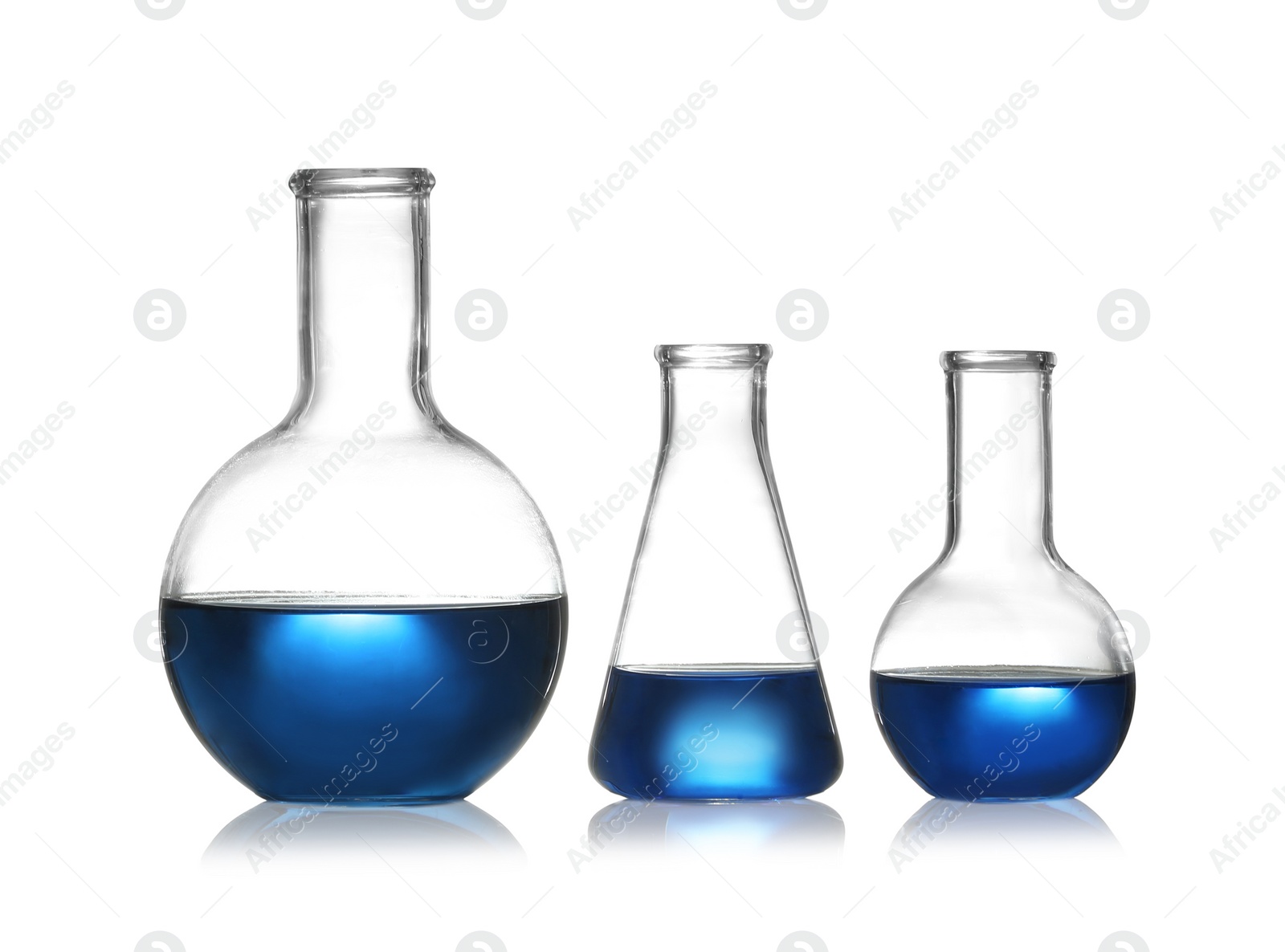 Photo of Group of chemistry glassware with liquid samples isolated on white