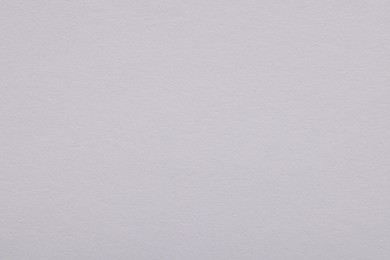 Photo of Texture of light grey paper sheet as background, top view