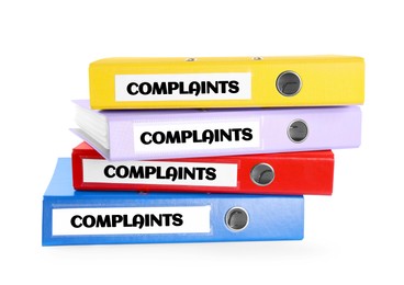 Colorful folders with Complaints labels on white background