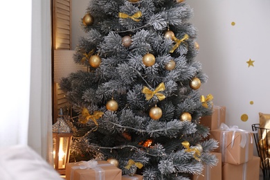 Photo of Stylish room interior with beautiful Christmas tree and gift boxes