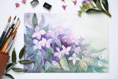 Photo of Flat lay composition with watercolor paints and floral picture on white background