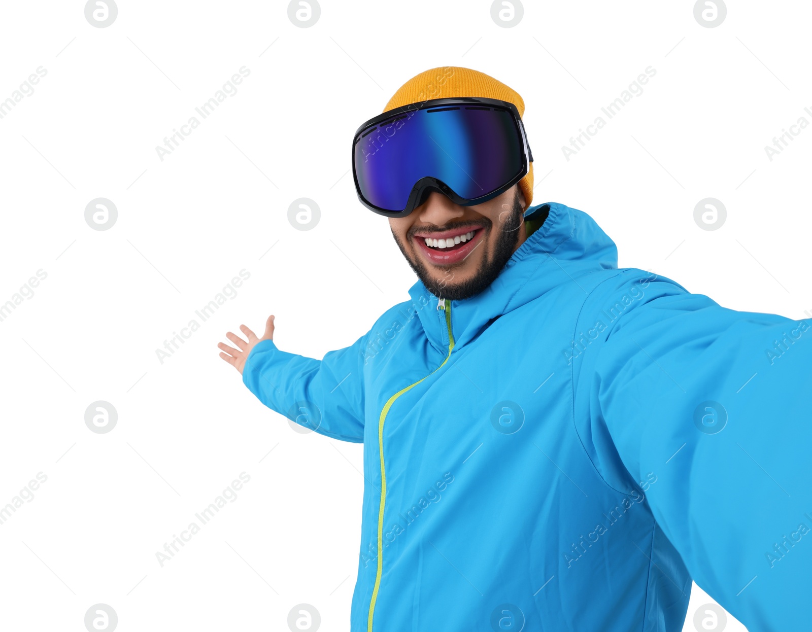 Photo of Smiling young man in ski goggles taking selfie on white background