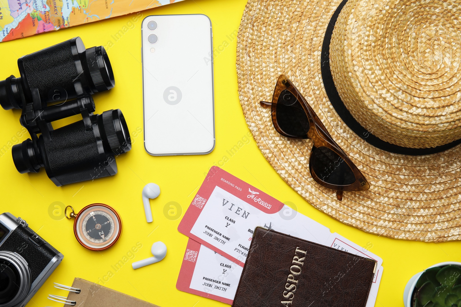 Photo of Flat lay composition with passport, tickets and travel items on yellow background