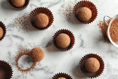 Photo of Flat lay composition with tasty raw chocolate truffles on marble background