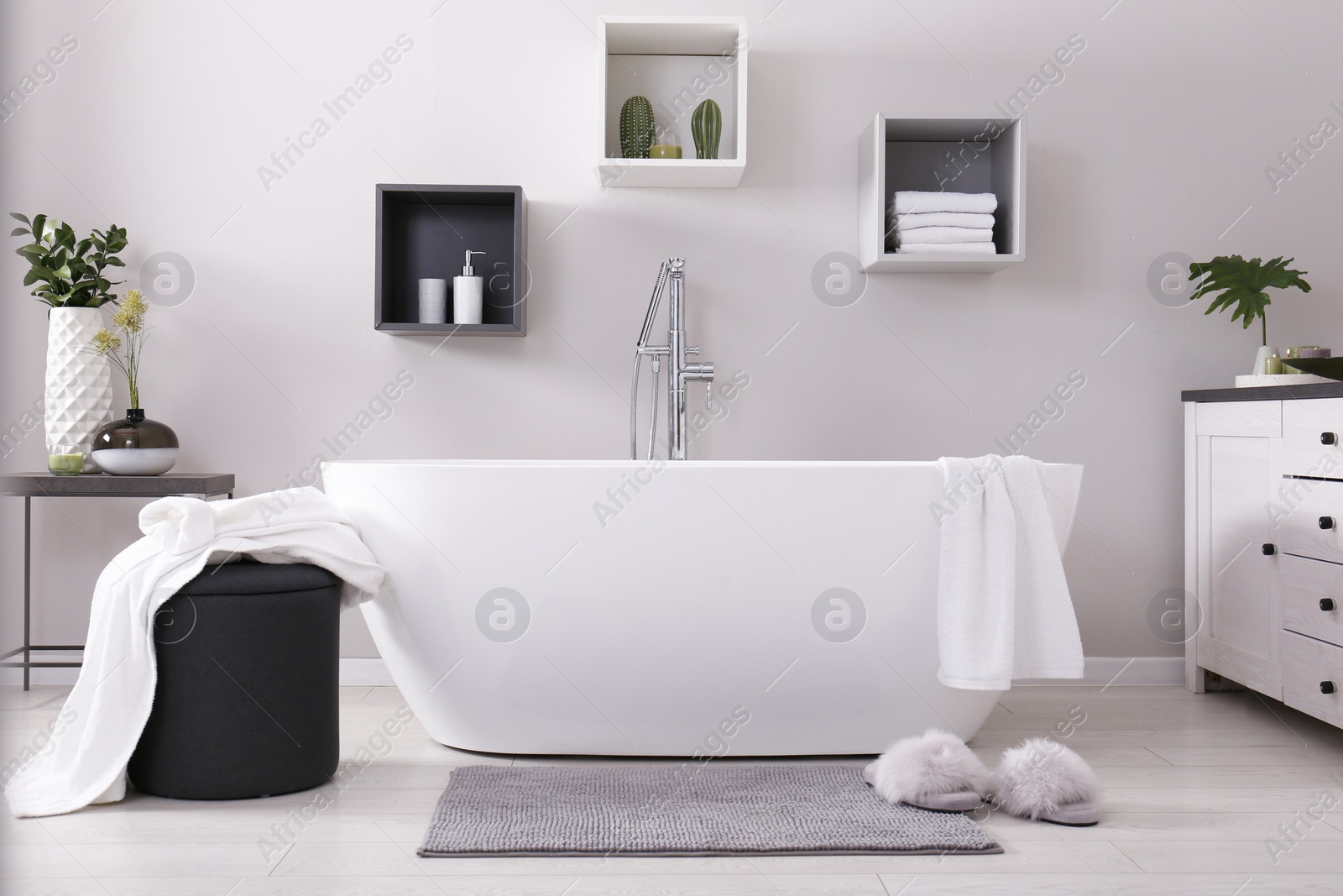 Photo of Stylish bathroom interior with modern white tub