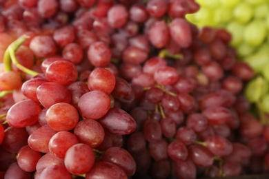 Photo of Fresh ripe juicy red grapes as background, closeup view