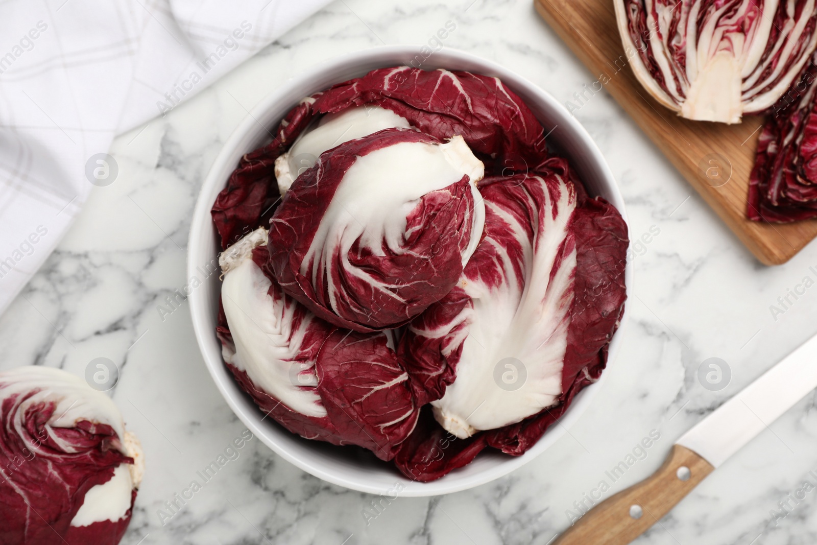 Photo of Whole fresh ripe radicchios on white marble table, flat lay