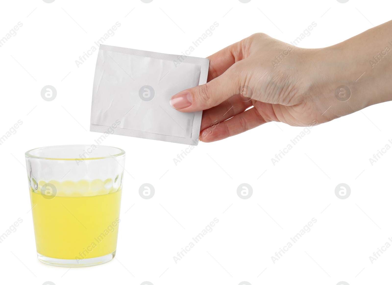 Photo of Woman pouring powder from medicine sachet into glass of water on white background, closeup