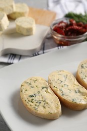 Photo of Tasty butter with dill and bread on table