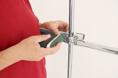 Photo of Worker installing new metal pipes with electric drill, closeup