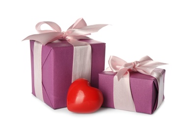 Photo of Beautiful gift boxes and red heart on white background. Valentine's Day celebration