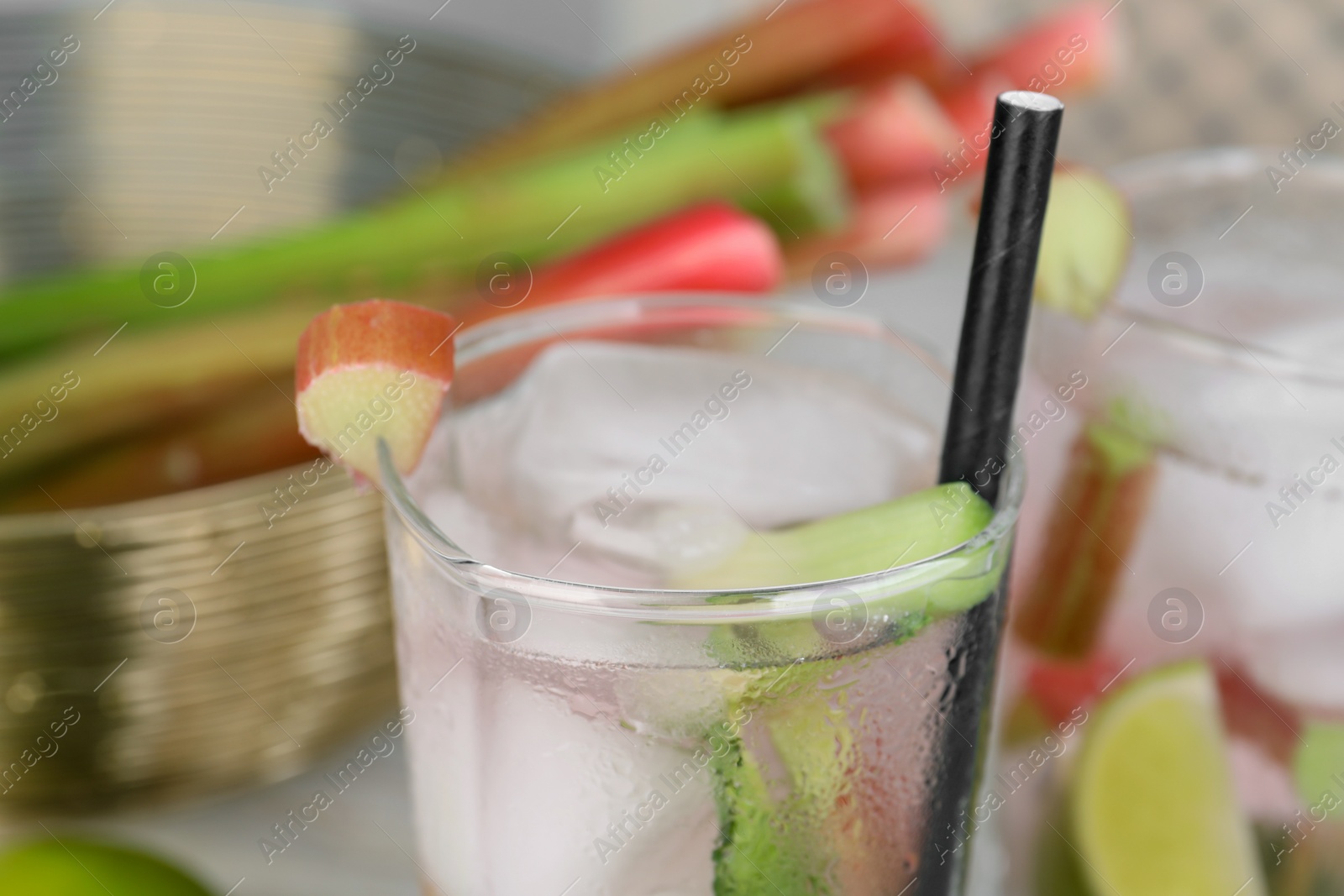 Photo of Glass of tasty rhubarb cocktail with lime, closeup