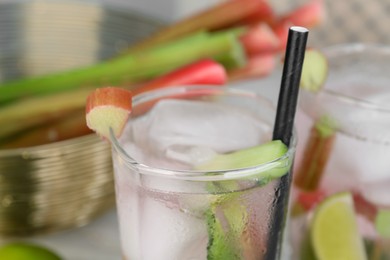 Photo of Glass of tasty rhubarb cocktail with lime, closeup