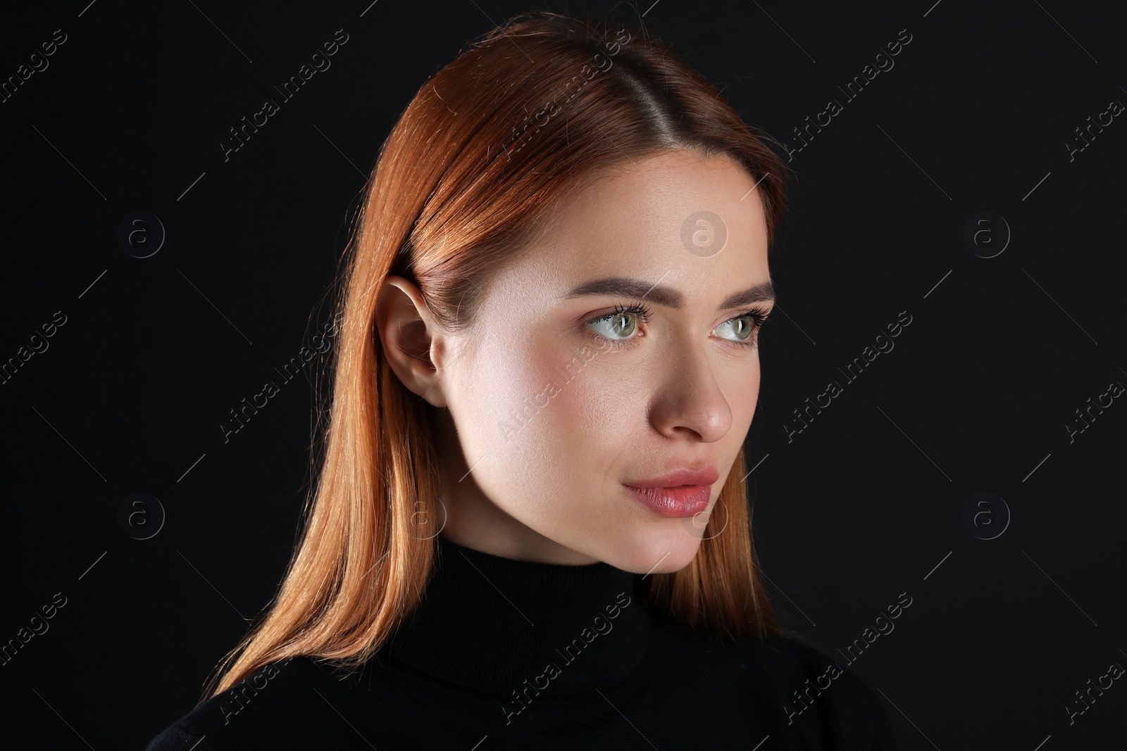 Photo of Evil eye. Young woman with scary eyes on black background