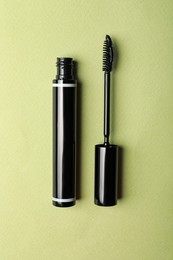 Photo of Mascara for eyelashes on light background, flat lay. Makeup product