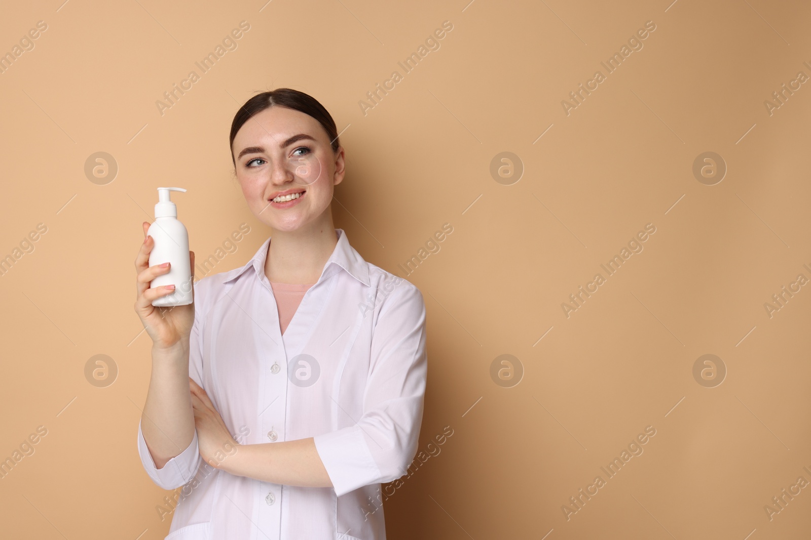 Photo of Cosmetologist with cosmetic product on beige background, space for text