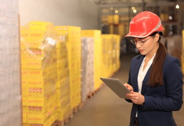 Manager with tablet working at warehouse. Logistics center