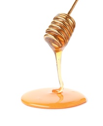 Honey dripping from dipper on white background