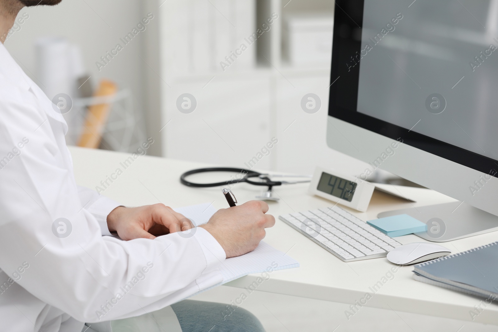 Photo of Doctor working at desk in office, closeup