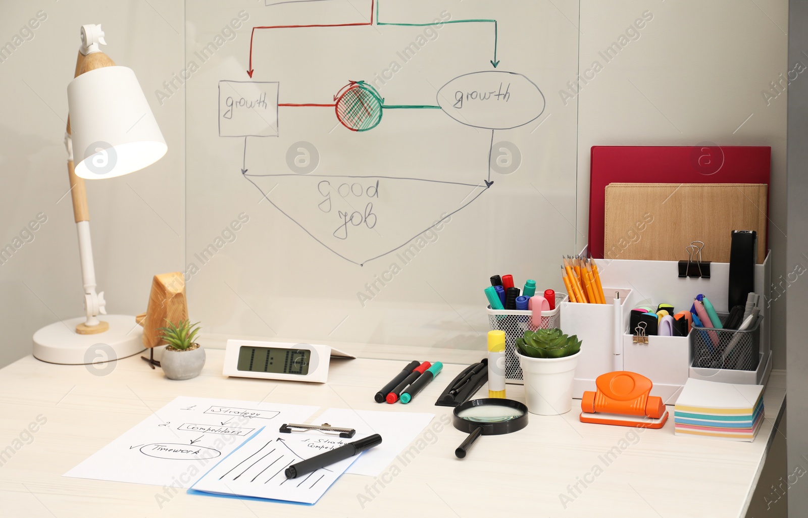 Photo of Business process planning and optimization. Workplace with lamp, notebook and other stationery on white wooden table