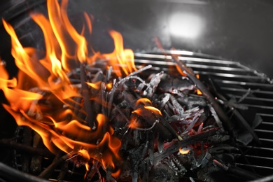 Photo of New modern barbecue grill with coals, closeup