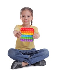 Photo of Little girl with pop it fidget toy on white background