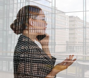 Image of Double exposure of businesswoman talking on phone and cityscape