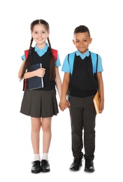 Photo of Full length portrait of cute children in school uniform with books on white background