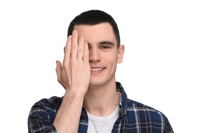 Young man covering his eye on white background