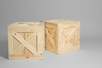 Photo of Pair of wooden crates on grey background