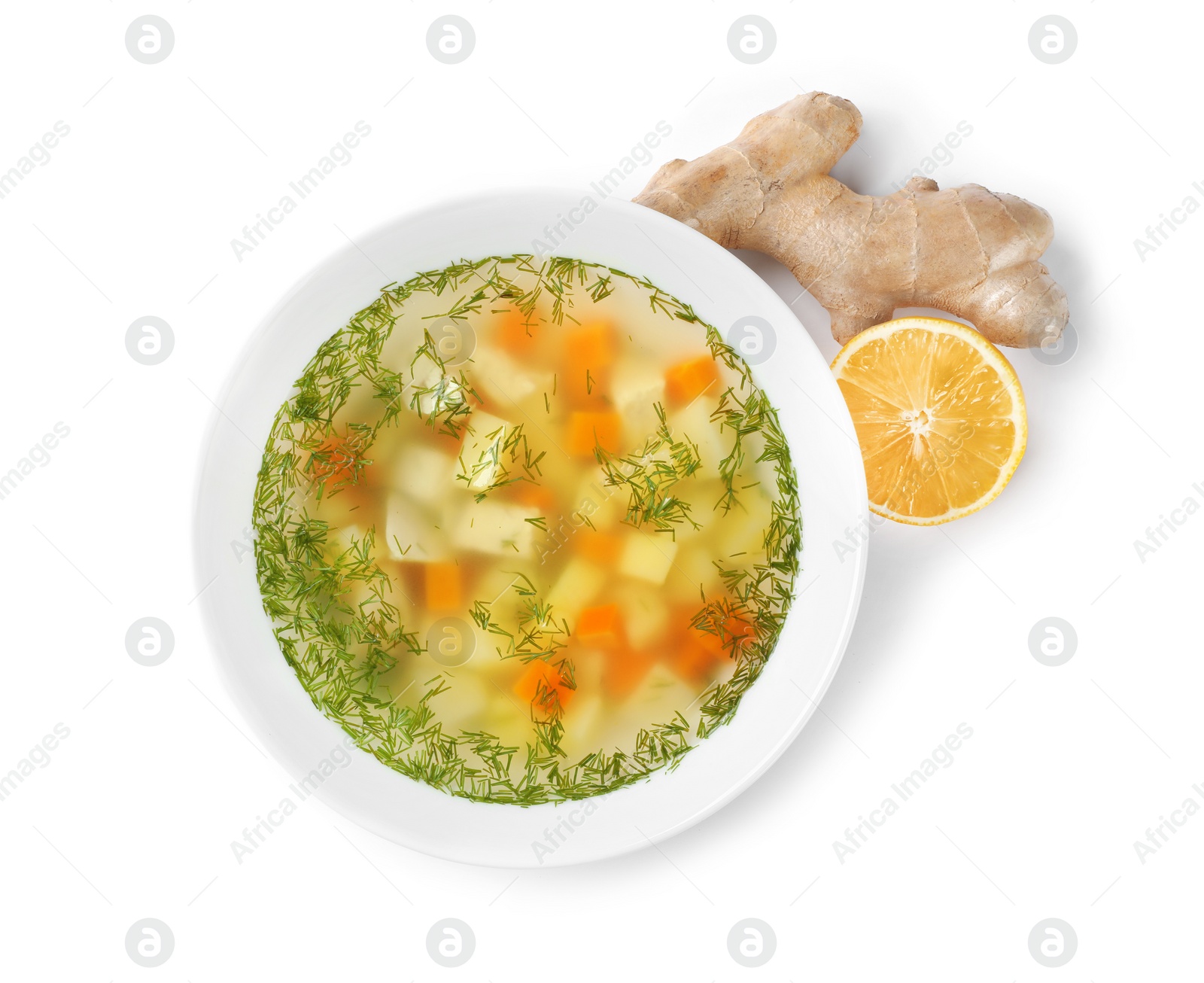 Photo of Bowl of fresh homemade soup to cure flu, lemon and ginger on white background, top view