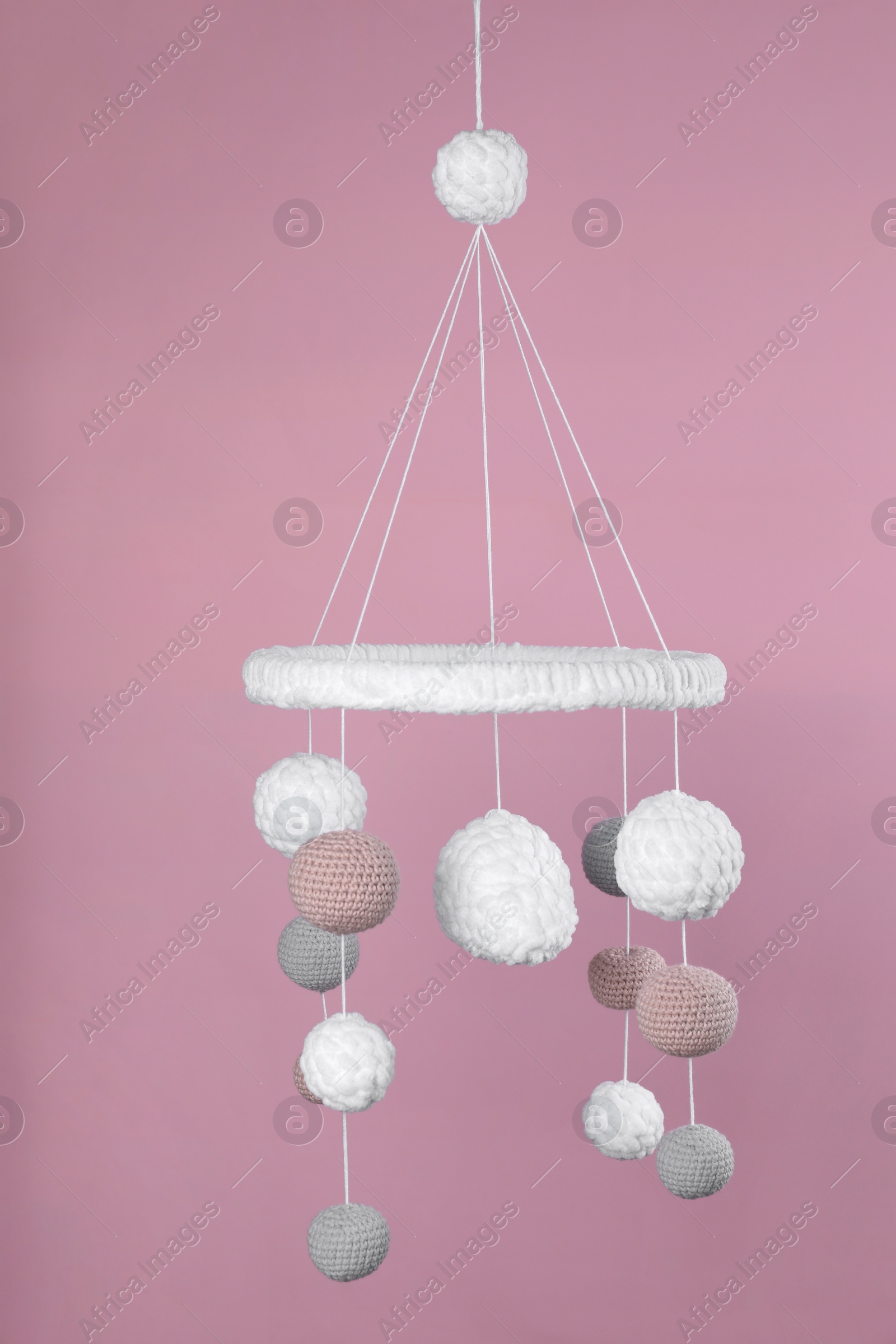 Photo of Cute baby crib mobile on pink background