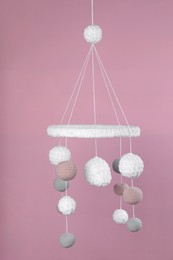 Photo of Cute baby crib mobile on pink background