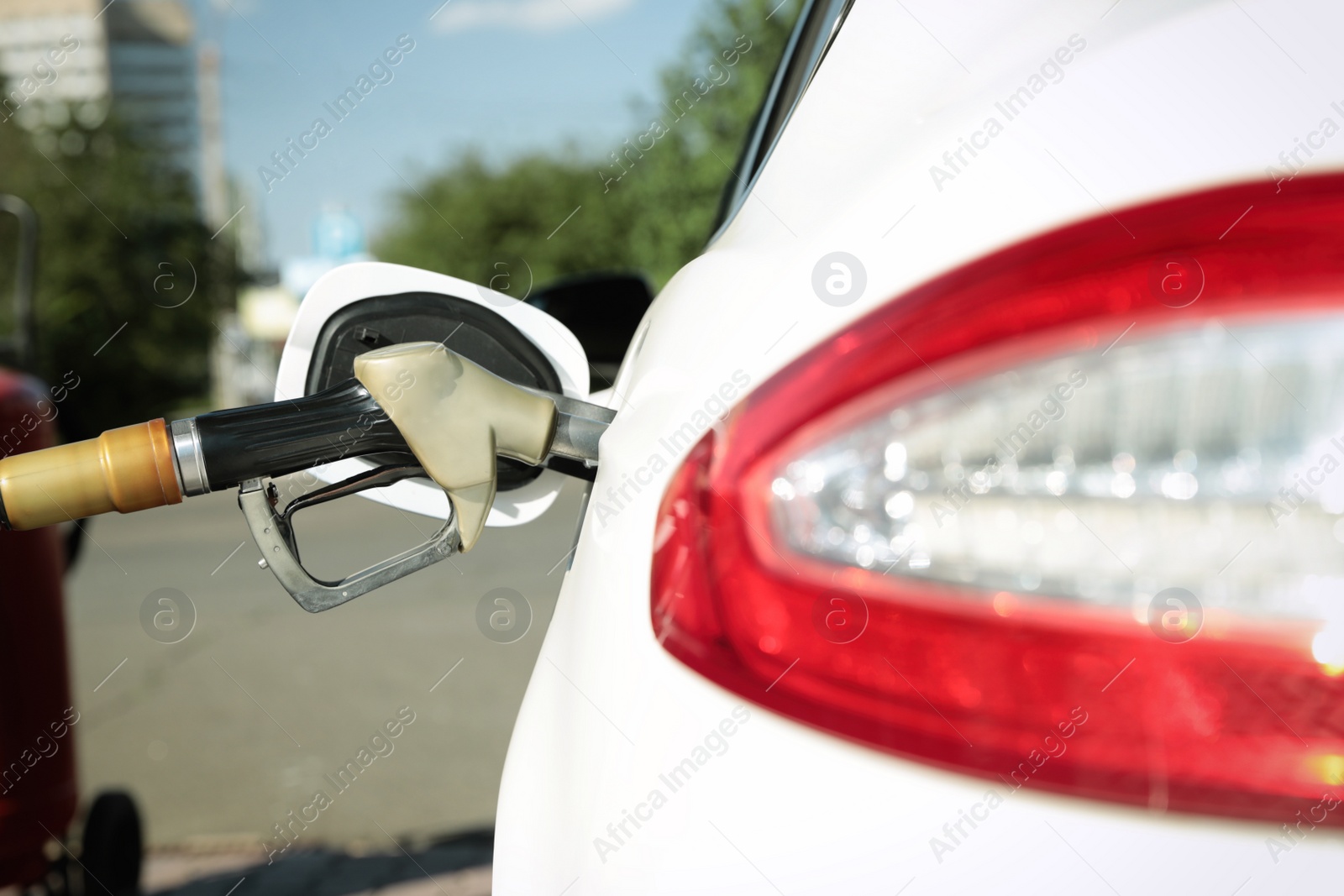 Photo of Refueling modern car with petrol pump on gas station, closeup